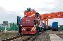  ?? HU XIAOFEI / FOR CHINA DAILY ?? Workers prepare a Yiwu-Xinjiang-Europe route China-Europe freight train for departure in Yiwu, Zhejiang province, on March 1. The train is scheduled to arrive in Paris after March 20.