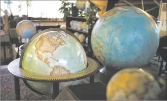  ?? AP photo ?? Various size of globes are displayed at a studio in London, on Feb. 27. Globes in the age of Google Earth capture the imaginatio­n and serve as snapshots of how the owners see the world and their place in it.
