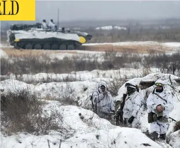  ?? SERGEI SUPINSKY / AFP / GETTY IMAGES ?? Ukrainian servicemen take part in tactical exercises near Goncharivs­ke village, not far from the border with Russia, on Monday. Tensions between the nations remained high after Russia’s seizure of three Ukrainian ships last week.