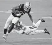  ?? ETHAN MILLER/GETTY IMAGES ?? Las Vegas Raiders tight end Darren Waller tries to elude New Orleans cornerback Marshon Lattimore.