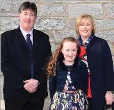  ??  ?? Béibhinn Sheehy who made her Confirmati­on with her parents Alan and Gemma at Holy Cross Church, Kenmare.