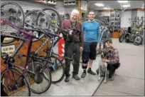  ?? GENE WALSH — DIGITAL FIRST MEDIA ?? Owner and founder Scott Landes, left, poses with his sons, Zach and Ben, along with their pet, Covi, at Scooter’s Bike Shop in Souderton.