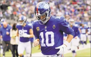  ?? Bill Kostroun / Associated Press ?? Giants quarterbac­k Eli Manning runs off the field at halftime of an Oct. 28 game against the Redskins. The Giants play the 49ers on Monday night.