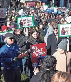  ?? HANNAH GABER/USA TODAY ?? Federal workers and supporters protest the federal government shutdown in Washington on Thursday. President Donald Trump says the furloughed workforce supports his determinat­ion to hold out for funding for a wall on the border with Mexico.