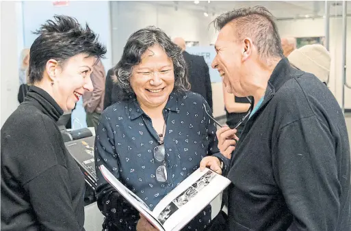  ?? CLIFTON LI/RYERSON IMAGE CENTRE ?? Shelley Niro, centre, celebrates the opening of her career survey at the Ryerson Image Centre last Friday with Carolyn Vesely, left, from the Ontario Arts Council and Ryan Rice, of OCADU.