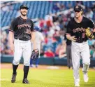 ?? ROBERTO E. ROSALES/JOURNAL ?? Isotopes pitcher Chad Bettis, left, was all smiles in Friday’s game, his second rehab start as he recovers from cancer.