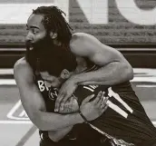  ?? Al Bello / Getty Images ?? James Harden, left, celebrates with Kyrie Irving after the Nets beat the Magic for their eighth straight win.