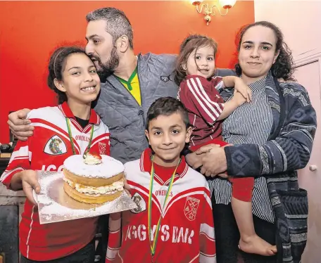  ?? PHOTO: RAY RYAN ?? Reunited: Lucivaldo Araujo da Silva is greeted by his daughter Stephany, son Bryan, daughter Nicole and wife Danielle, as he arrived back home in Athenry.