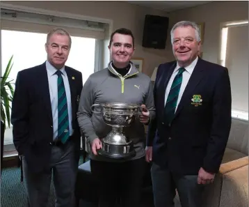  ??  ?? Blainroe Golf Club captain of 2017 Kevin O’Gorman and current captain Peter Burgess present Chris Sheehy with the Collins Cup at the Blainroe Golf Club AGM 2017.