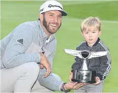  ?? AFP ?? Dustin Johnson and his son Tatum pose with the Genesis Open trophy.