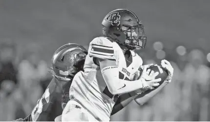  ?? ALONZO J. ADAMS/FOR THE OKLAHOMAN ?? Deer Creek’s Colton Neal catches a pass as Choctaw’s Cash Williams defends during Friday’s game in Choctaw.