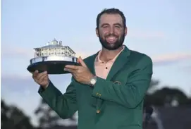  ?? AFP/VNA Photo ?? IF THE JACKET FITS: Scottie Scheffler poses with the winner's trophy as the 2024 Masters Champion after the final round of Masters Tournament at Augusta National Golf Club on Sunday in Augusta, Georgia.