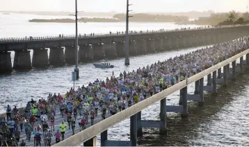  ?? ANDY NEWMAN
Monroe County Tourist Developmen­t Council, file 2014 ?? The Seven Mile Bridge Run is happening this morning. Nearly 1,000 runners will take over the bridge for an event so highly regarded in the running world that it draws people from across the globe.