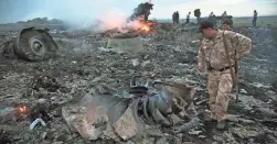  ?? ?? Debris from the downed Malaysia Airlines flight MH17 is strewn near Grabovo, Ukraine, in 2014. The team investigat­ing the incident is suspending its 81⁄2-year inquiry.