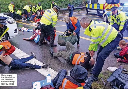  ?? ?? Members of Insulate Britain are removed from blocking a road by police