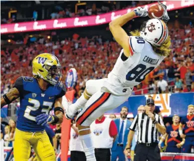  ?? TODD VAN EMST/AUBURN PHOTO ?? Sal Cannella comes down with a catch for Auburn’s first touchdown of the 2018 season Saturday afternoon in the 21-16 victory over Washington in the Chick-fil-A Kickoff Game inside Atlanta’s Mercedes-Benz Stadium.