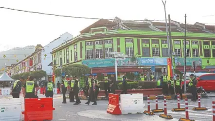  ?? — KK SHAM/THE Star ?? Getting ready: police personnel standing by outside the nomination centre in Kuala Kubu Baharu yesterday. it’s a new by-election but with the same old narrative about identity politics.