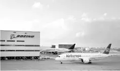  ??  ?? A Boeing Dreamliner 787 with AirEuropa livery moves past Boeing’s final assembly facility in North Charleston.