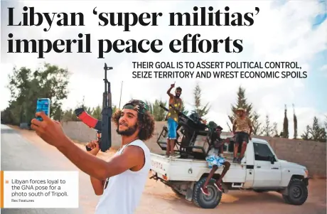  ?? Rex Features ?? Libyan forces loyal to the GNA pose for a photo south of Tripoli.