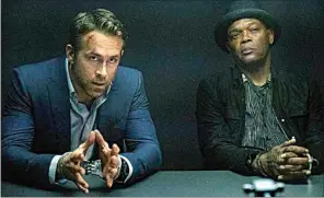  ?? DAVID APPLEBY / LIONSGATE VIA AP ?? Ryan Reynolds, left, and Samuel L. Jackson appear in a scene from “The Hitman’s Wife’s Bodyguard.”