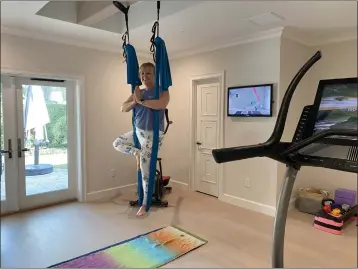  ?? COURTESY OF MARNI JAMESON ?? Carol Zurcher expanded and updated her home gym during the pandemic by adding a high-tech NordicTrac­k and aerial yoga hammock.