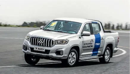  ??  ?? An LDV T60 ute gets the full cornering treatment during a media day at China’s Guangde Proving Ground.