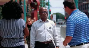  ?? ANGELA PETERSON/MILWAUKEE JOURNAL SENTINEL ?? Earnell Lucas (center), who won the Democratic primary for Milwaukee County sheriff, talks with supporters Isioma Nwabuzor (left) and Charley Weber earlier Tuesday at Public Market.