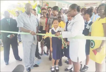  ??  ?? Minister of Education Nicolette Henry cutting the ribbon yesterday to officially open the 14th Biennial STEAM Fair at St Joseph High School, Woolford Avenue, Georgetown.