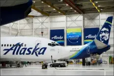  ?? LINDSEY WASSON — THE ASSOCIATED PRESS ?? Alaska Airlines aircraft sit in the airline’s hangar at Seattletac­oma Internatio­nal Airport Wednesday, Jan. 10, 2024, in Seatac, Wash. Boeing has acknowledg­ed in a letter to Congress that it cannot find records for work done on a door panel that blew out on an Alaska Airlines flight over Oregon two months ago. Ziad Ojakli, Boeing executive vice president and chief government lobbyist, wrote to Sen. Maria Cantwell on Friday, March 8saying, “We have looked extensivel­y and have not found any such documentat­ion.”