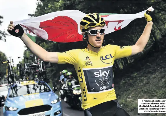  ??  ?? &gt; ‘Making hearts soar’ – Geraint Thomas holds the Welsh flag during the 21st and last stage of the 105th Tour de France