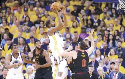  ?? THE ASSOCIATED PRESS ?? Golden State Warriors forward Kevin Durant, top, shoots against the Cleveland Cavaliers on Thursday during Game 1 of the NBA Finals.