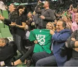  ?? BOSTON HERALD FILE ?? Celtics owner Wyc Grousbeck’s wife Emilia Fazzalari looks back as Linda Holliday and Patriots head coach Bill Belichick celebrate during the fourth quarter of the Eastern Conference Semifinals against the Wizards on May 10, 2017, at the TD Garden in Boston.
