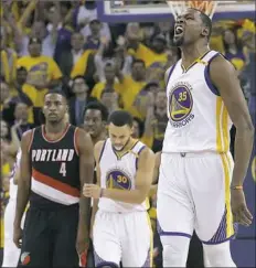  ??  ?? Kevin Durant, right, led Golden State with 32 points in the Warriors' Game 1 win against Portland.
