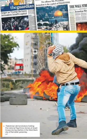  ?? AFP ?? Palestinia­n demonstrat­ors holding the national flag throw stones at Israeli troops during clashes in the West Bank city of Ramallah yesterday.