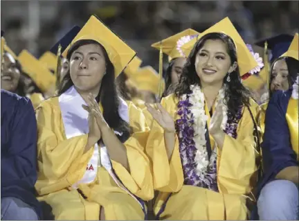  ?? VINCENT OSUNA PHOTO ?? Students from Calipatria High School's Class of 2017 applaud during a speech from class Salutatori­an Norma Damian Vilchez during their graduation ceremony at Veteran's Field in Calipatria on Friday night.