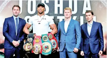  ??  ?? (From left) Promoter Eddie Hearn, Anthony Joshua, Alexander Povetkin and Povetkin’s manager Vadim Kornilov pose for a photograph after the press conference. — Reuters photo