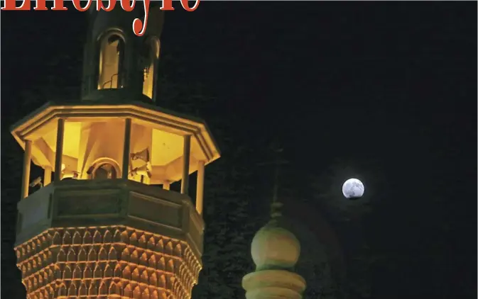  ?? — Photo by Yasser Al-Zayyat ?? A picture shows the moon during a partial lunar eclipse as seen from Kuwait City on August 7, 2017.