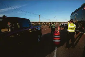 ?? Adriana Zehbrauska­s / New York Times ?? New Mexico State Police help to maintain a roadblock set up at one of the entrances to Gallup, turning away outsiders. The Gallup lockdown comes in response to a worsening virus outbreak.