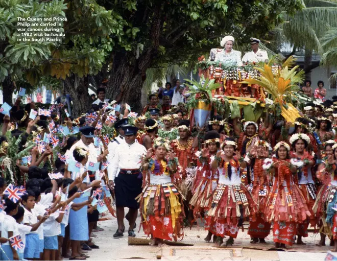  ??  ?? The Queen and Prince Philip are carried in war canoes during a 1982 visit to Tuvalu in the South Pacific