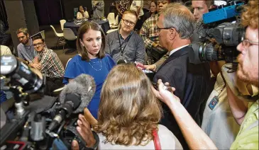  ?? STEVE SCHAEFER/SPECIAL TO THE AJC ?? Former state Rep. Stacey Evans talks with reporters during her party Tuesday night at the Gathering Spot in Atlanta. Evans immediatel­y struck a note of conciliati­on and unity by endorsing Stacey Abrams for governor.