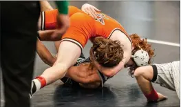  ?? NATE HECKENBERG­ER - FOR MEDIANEWS GROUP ?? Perkiomen Valley’s Kelly Kakos scores near-fall points against Abington Heights’ Austin Smith before pinning him in the 132-pound consolatio­n semifinal. Kakos finished third.