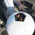  ??  ?? Easy does it . . . MetService technician­s and contractor­s prepare to lift the radome (the protective sphere which houses the radar equipment) into place on top of a tower.
