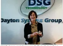  ?? THOMAS GNAU / STAFF ?? Vicki Bachmann, marketing manager for Dayton Systems Group, holds the metal parts her company devised to make “crowlers” resealable and ready to go.