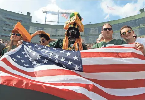  ?? MARK HOFFMAN, USA TODAY SPORTS NETWORK ?? Green Bay fans wave the American flag following the national anthem Sunday.