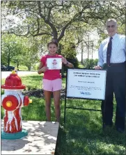  ?? SUBMITTED PHOTO ?? Ava Kloufetos, left, and North Penn Water Authority Executive Director Tony Bellitto pose with a hydrant decorated with Ava’s design, chosen as the winner of an annual NPWA contest.