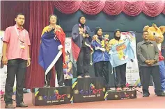  ??  ?? Cristina (second left) at the prize ceremony of the women’s Class E in silat events.