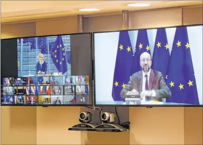  ?? Olivier Hoslet The Associated Press ?? European Council President Charles Michel, right, speaks to EU leaders during a summit Friday in Brussels.