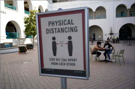  ?? AP FILE PHOTO/
GREGORY BULL ?? In this Sept. 2 file photo, people sit at tables at San Diego State University in San Diego.