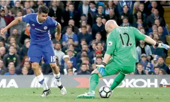  ?? — AP ?? Chelsea striker Diego Costa scores past Middlesbro­ugh goalkeeper Brad Guzan at Stamford Bridge in London on Monday. Chelsea won 3-0.