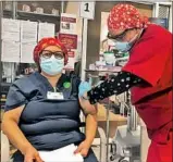  ?? Gabriella Robison Keck Medicine of USC ?? MARIA SARAVIA, 56, a cleaner at Keck Hospital of USC, receives the COVID- 19 vaccine.